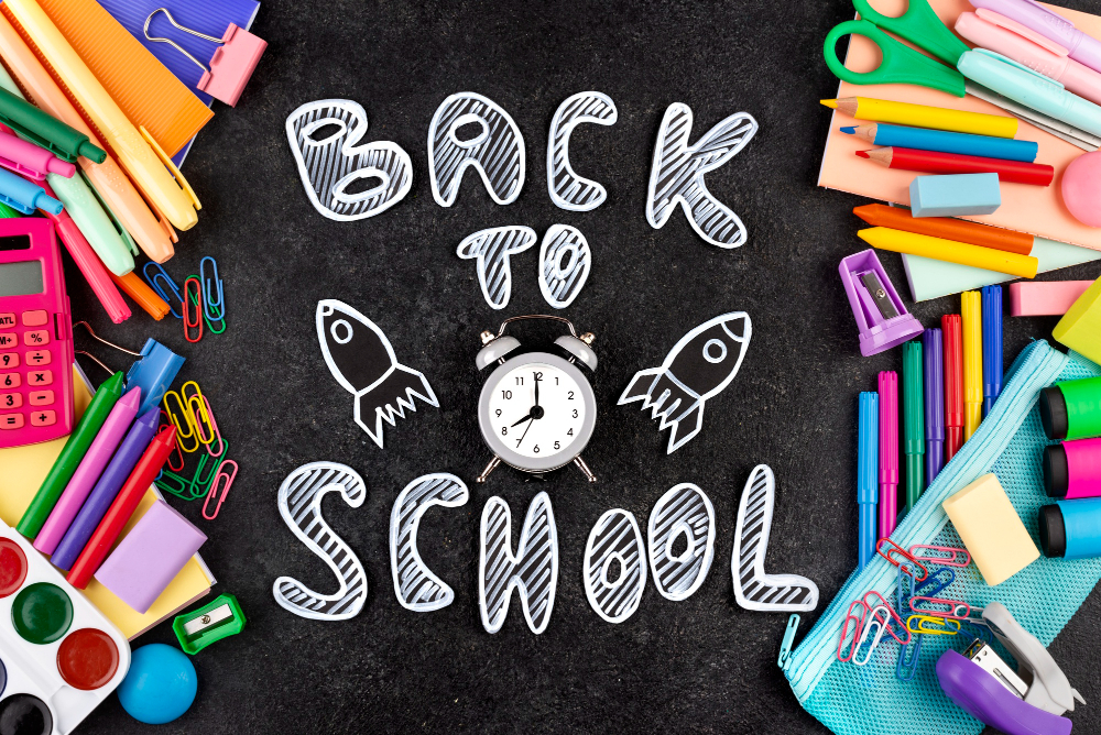 Back to school background with school supplies on chalkboard